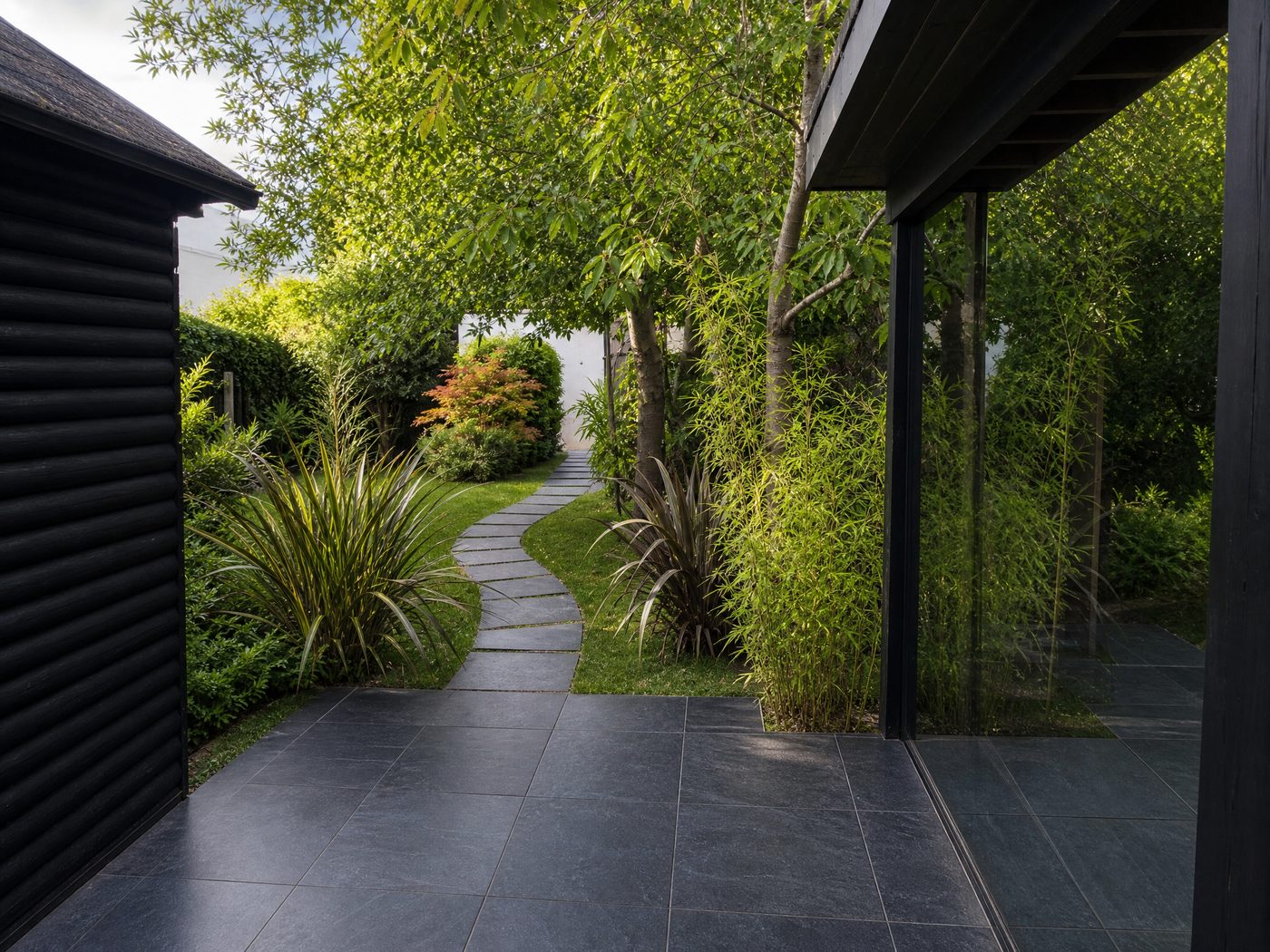 Winding slate pathway through private garden to treatment space