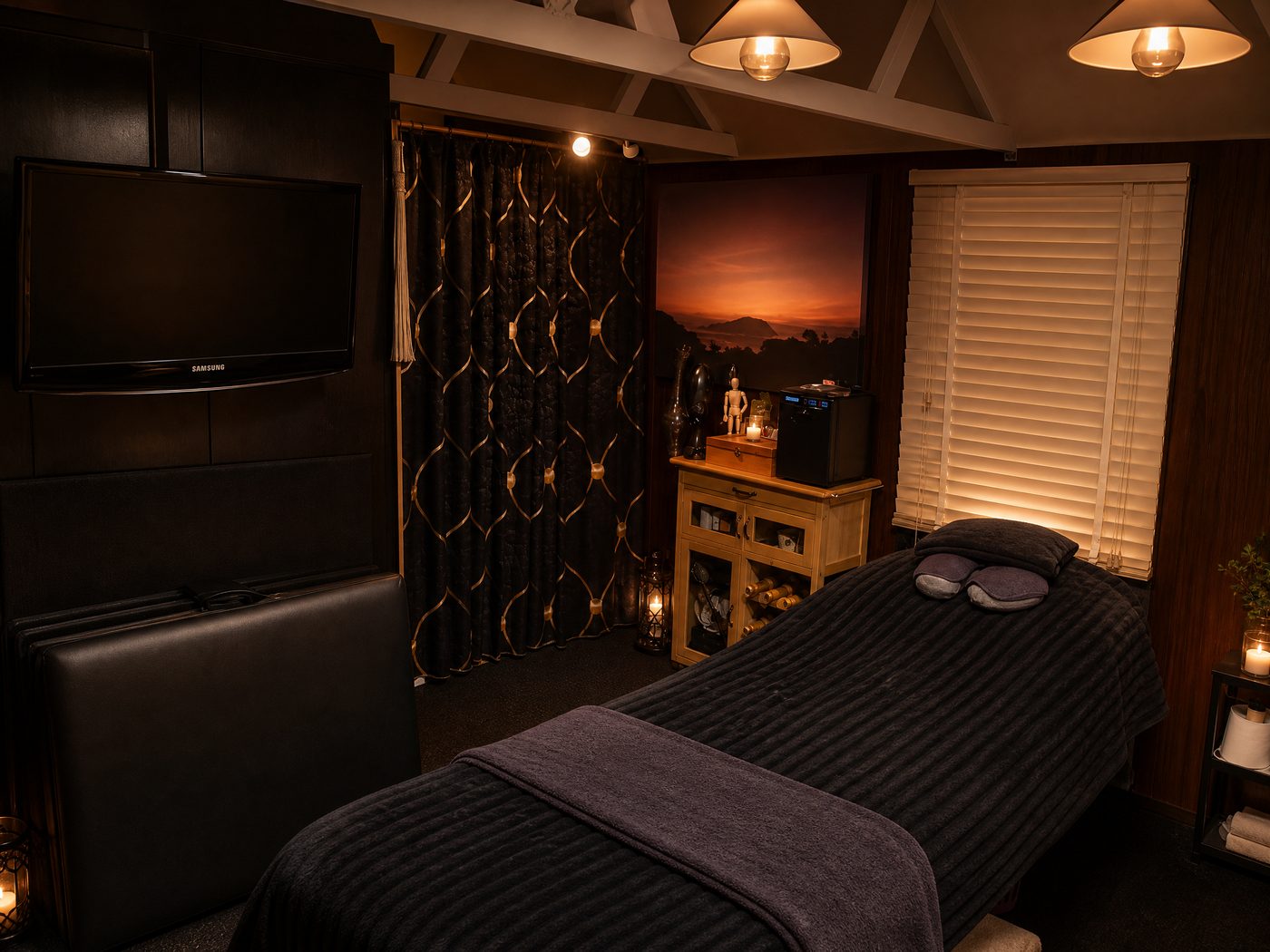 The Secret Interior treatment room — candlelit sanctuary with massage table and warm ambient lighting